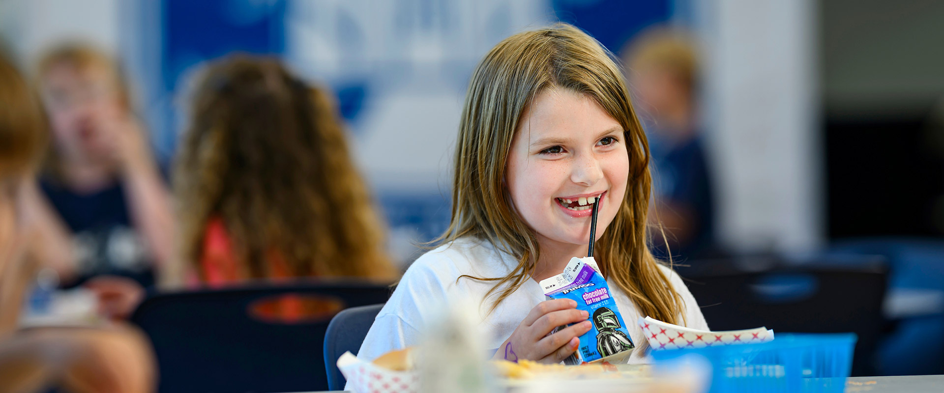 Student drinking milk from a carton