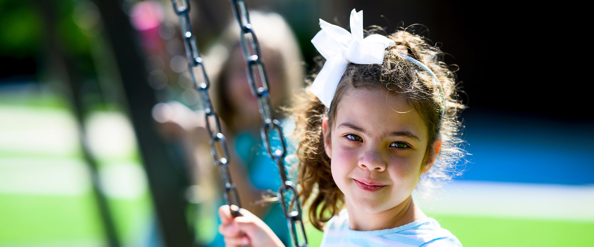 Kindergarten girl on swings